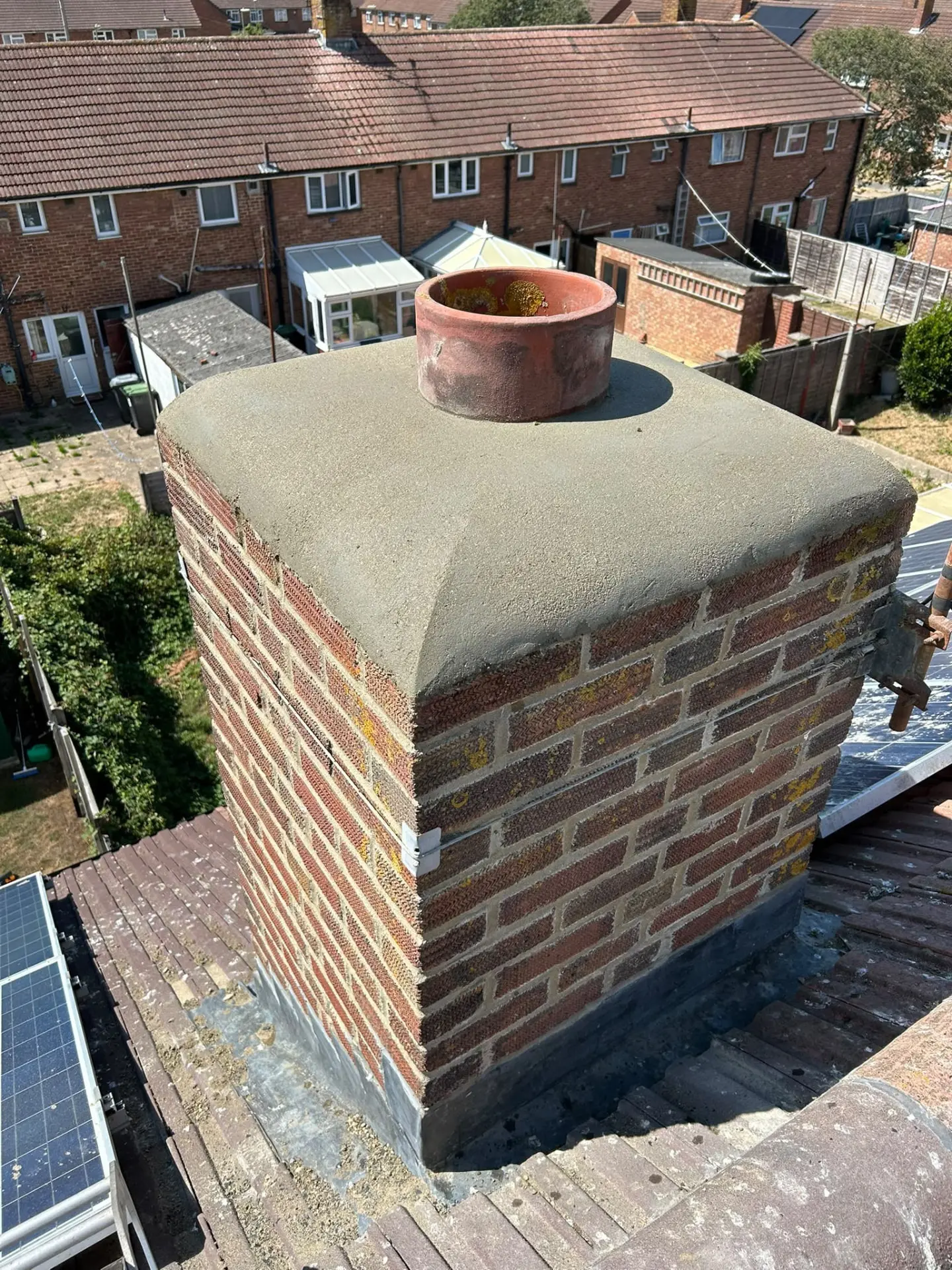 Rebuilt brick chimney stack with fresh flaunching, new pot and lead soakers