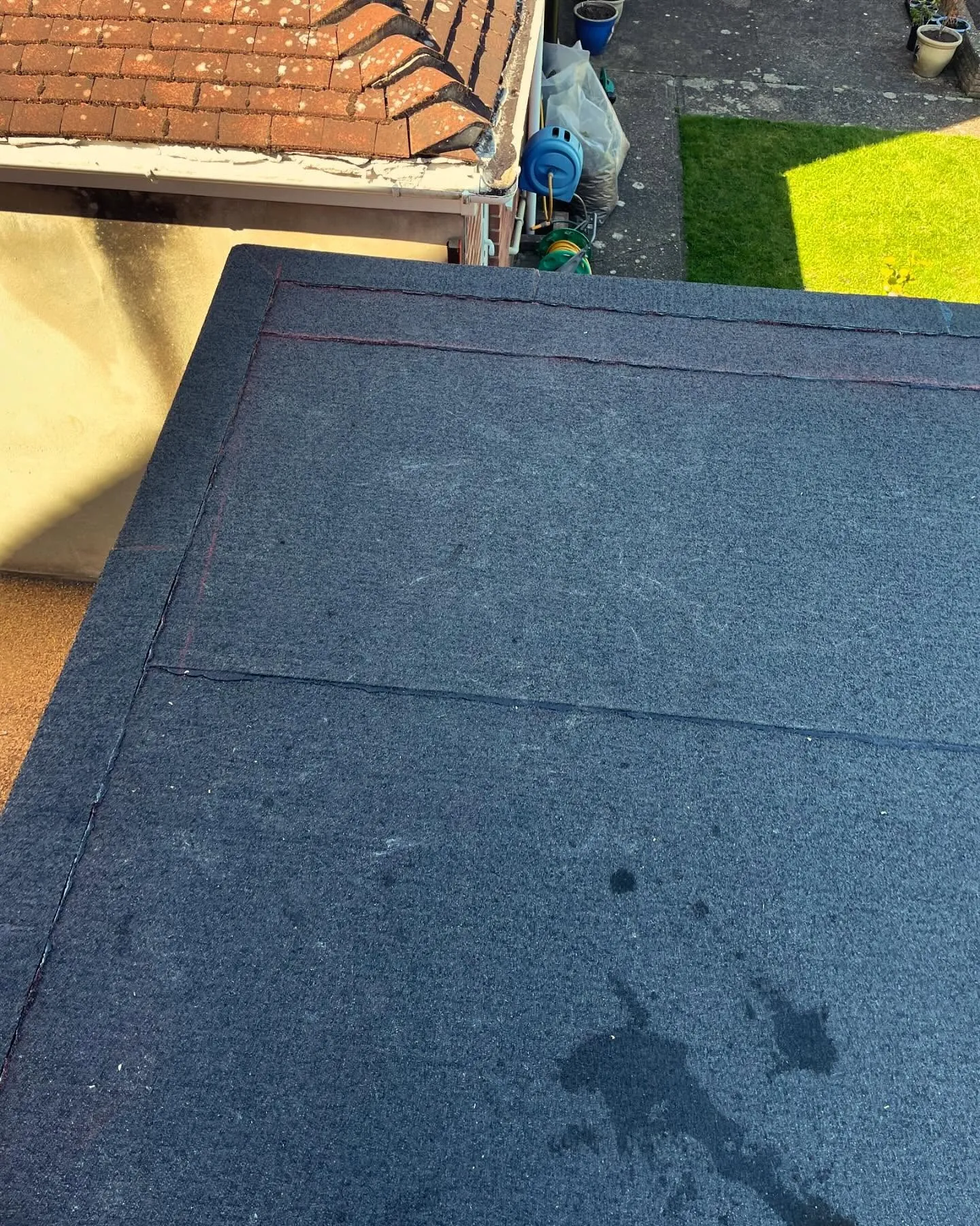 Same roof finished with a new felt covering and clean perimeter trims