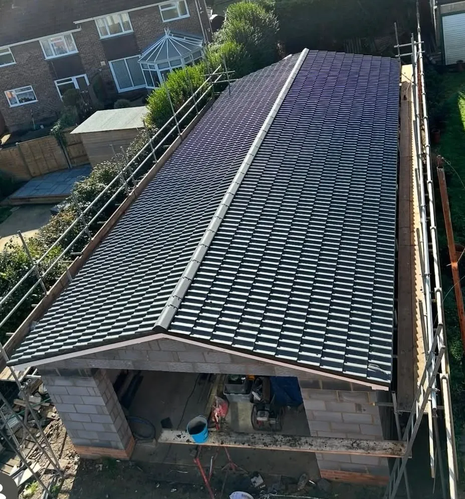 Newly tiled garage roof maintained and finished with scaffolding still in place