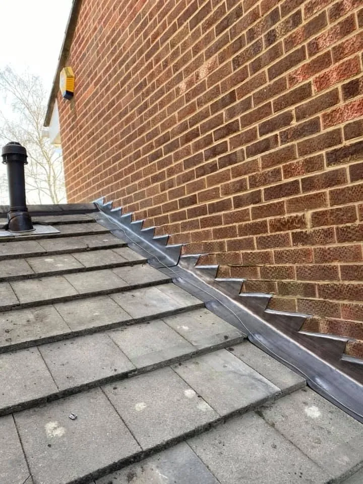 Hand-dressed stepped lead flashing finished against a brick wall, Hampshire (7)
