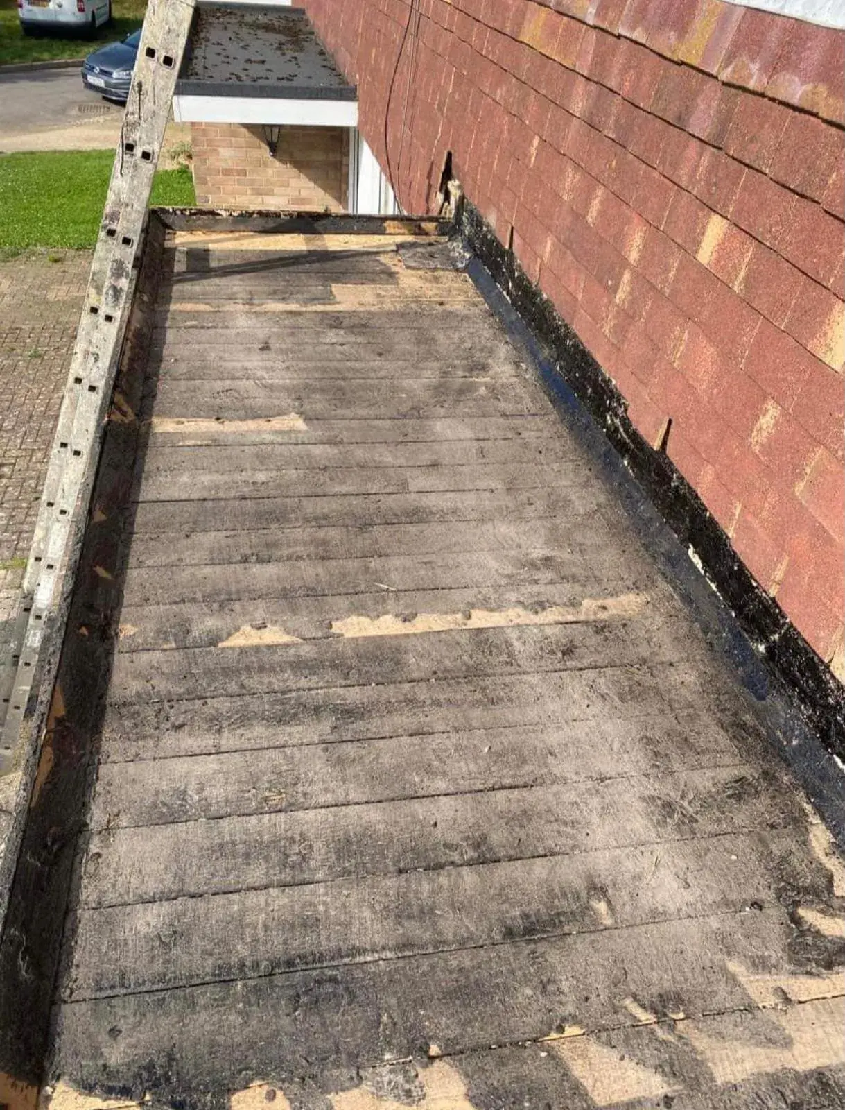 Bay window flat roof stripped back to bare timber boards before re-covering
