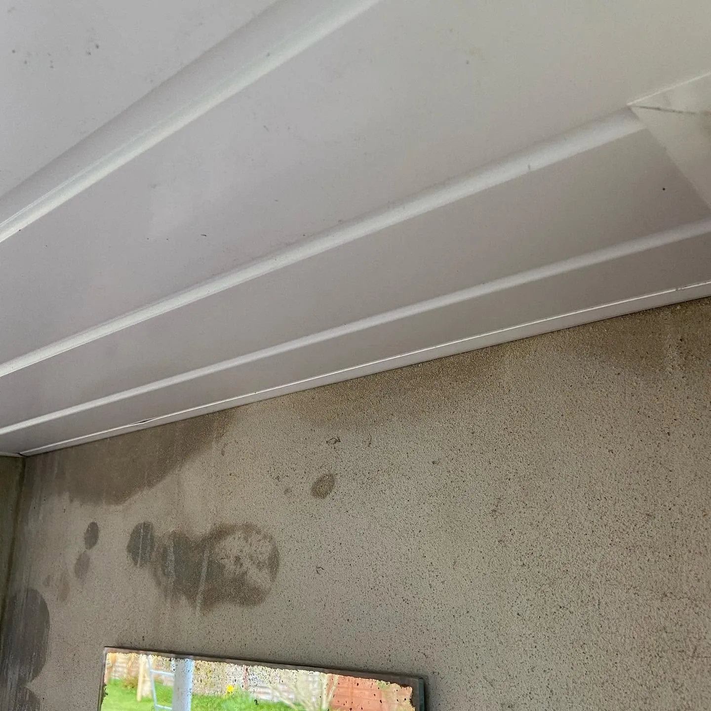 Veranda soffit finished in new white uPVC cladding (after)