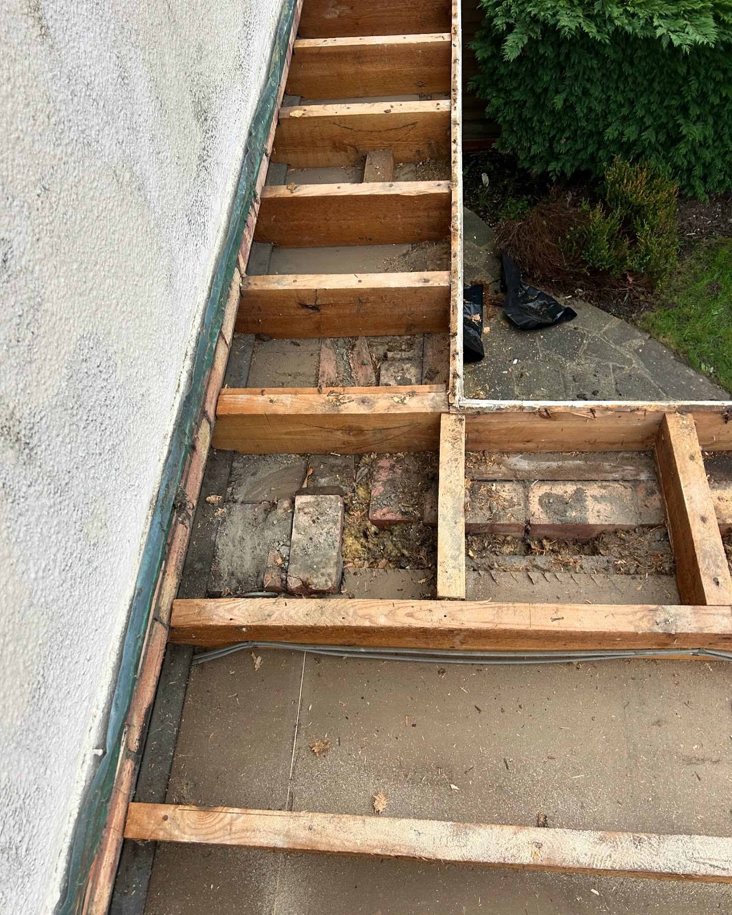 Flat roof opened up to bare joists before the new deck went down