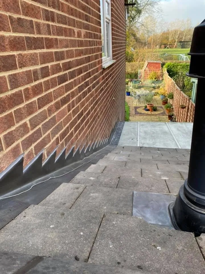 Hand-dressed stepped lead flashing finished against a brick wall, Hampshire (8)