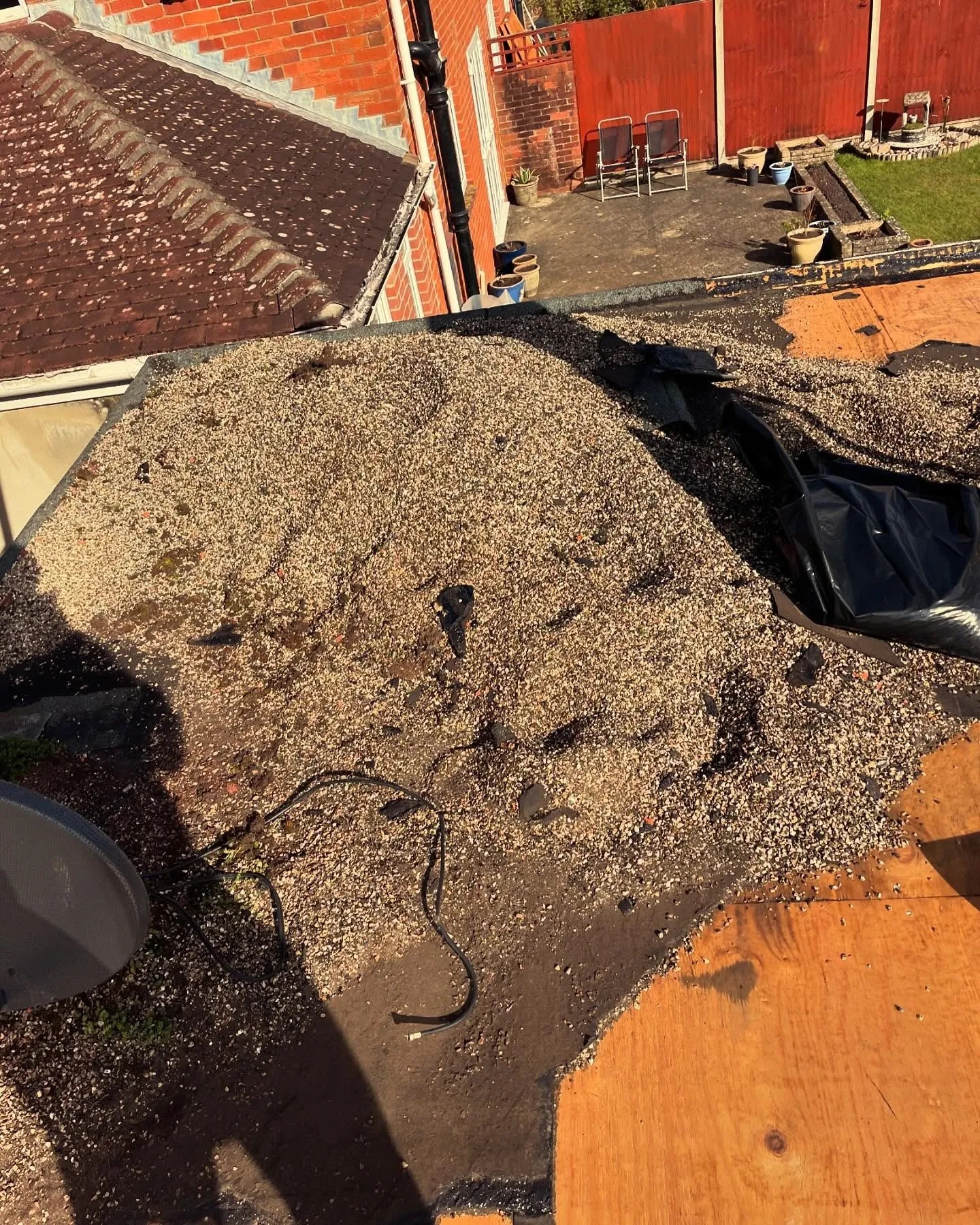Failed flat roof stripped back to sodden insulation and old boards